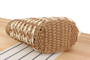 Detailed oval base view of two-tone woven straw tote bag for summer vacations