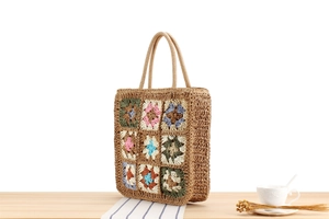 Detailed close-up of handmade crochet bag with colorful retro bohemian floral pattern squares