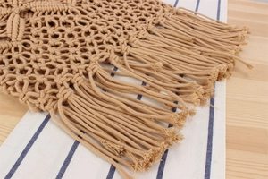 Macro view of khaki hand-woven cotton rope mesh bag featuring intricate hollow-out patterns