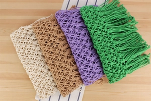 Close-up of handmade Bohemian woven cotton bags in various colors with long tassels