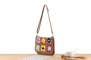 Detail of bohemian handmade crochet crossbody bag with colorful floral granny square patterns