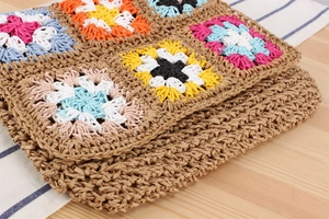 Detailed view of bohemian floral crochet pattern on handmade woven crossbody bag