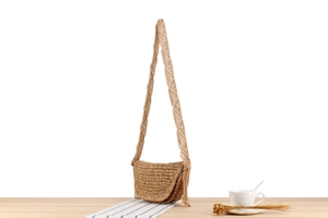 Detail of bohemian woven crossbody bag with tassel and braided wheat-ear shoulder strap