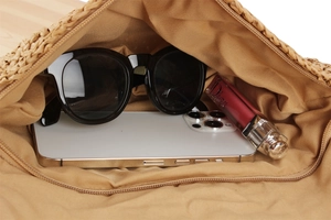 Internal view of the woven paper rope bag showing phone and sunglasses storage space