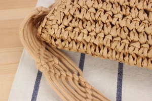 Close-up of woven paper rope texture and handcrafted shoulder strap on leisure bag