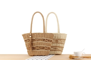 Close-up of woven straw tote bags with wave pattern, tassels and wooden bead details