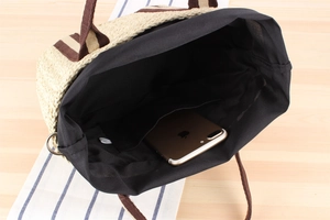 Internal view of the woven tote bag showing large capacity and black fabric inner lining