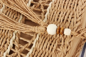 Detailed close-up of woven paper rope bag texture with wooden beads and tassel detail