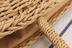 Macro detail of hand-woven straw bag handle and natural fiber texture with inner lining