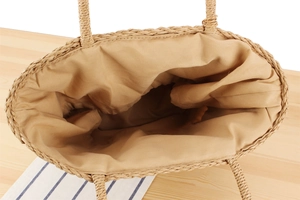 Close-up of handwoven straw tote bag with fabric lining and spacious interior