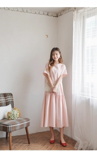 Detail view of pink tiered cotton dress with elegant pleats for summer beach vacation