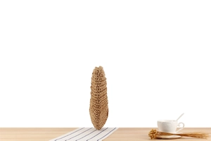 Detail of hand-woven straw texture on a bohemian moon bag with natural raffia fibers