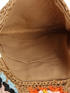 Interior view of vintage floral crochet crossbody bag with brown lining and inner pocket