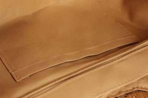 Detail of the woven bag interior featuring canvas lining and a secure zipper pocket