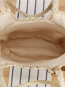 Large bohemian straw tote bag featuring a zip closure and spacious interior lining
