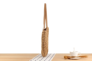 Side view of handmade paper rope woven beach bag with slim leather shoulder straps