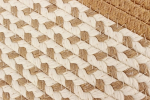 Detail of bohemian hand-woven bag showing natural cotton and jute fiber texture