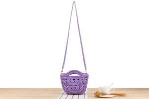 Détail d'un sac seau en crochet violet clair fait main avec des motifs ajourés