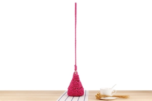 Gros plan d'un sac seau rose fuchsia crocheté main avec bandoulière tressée et texture