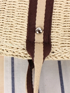 Minimalist paper straw tote bag with vertical fabric strap and polished silver rivet detail