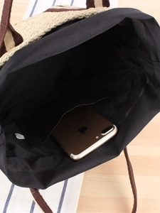 Vertical straw woven tote bag with beige-brown texture and spacious black interior lining