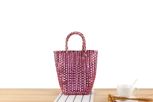 Détail du sac cabas tissé main en maille métallique fuchsia et or avec anses solides