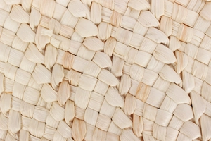 Detailed macro view of high-quality natural raffia weave texture for summer tote bag