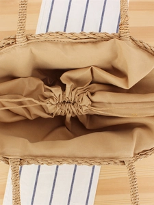 Handmade straw tote bag with drawstring lining and natural woven texture for summer