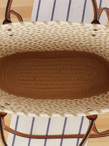 Bohemian hand-woven tote bag with brown leather handles and spacious interior structure