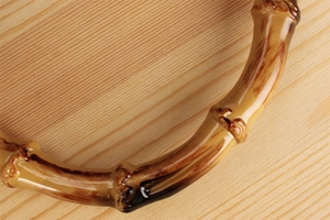 Close-up of vintage bamboo handle with natural knots and dark burnt texture detail