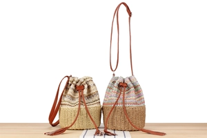 Close-up of woven bucket bags with tassel drawstrings and colorful wave patterns