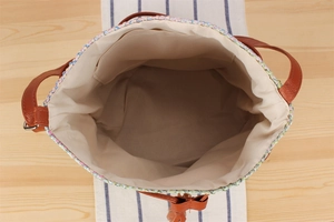 Top view of woven tote bag showing spacious interior lining and small inner pocket