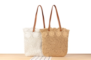 Detailed close-up of handmade woven tote bag with intricate floral cut-out patterns