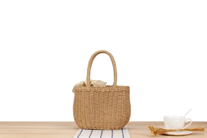 Detailed close-up of the woven paper rope texture and vintage lace lining of the beach tote