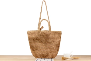 Detail of bohemian paper rope woven tote bag with ribbon bow and dual shoulder straps
