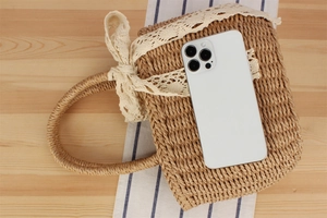 Detail view of handmade woven paper rope bag with lace bow and wood-tone texture