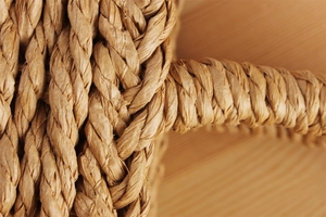 Macro shot of natural hand-woven paper rope textures on a beach vacation handbag