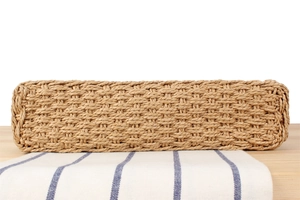 Close-up of the natural woven texture and cross-stitch pattern on a beach tote bag