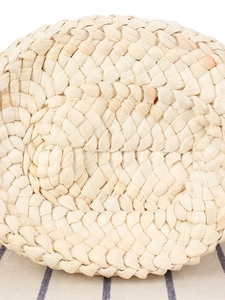 Handwoven round corn husk tray with natural fibers and minimalist aesthetic