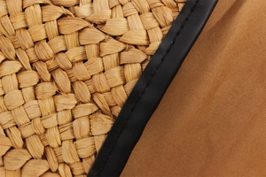 Detail of handmade corn husk woven bag with black leather edging and fine stitching
