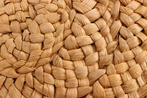 Macro shot of natural corn husk weave detailing the authentic handmade texture of this bag