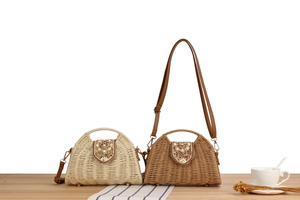 Detail of woven paper rope bag with shell and bead embellishments on wooden table