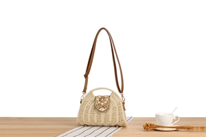 Detail of paper rope woven bag with colorful bead accents and brown leather strap