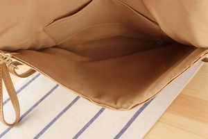Detalle del interior del bolso de paja con forro, bolsillo y cremallera metálica