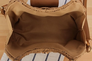 Top-down detail of the paper rope woven bag showing the khaki fabric lining and metal ring