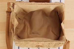 Top view of woven paper rope crossbody bag showing khaki interior lining and magnetic buckle