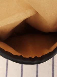 Minimalist handmade corn husk straw bag with soft lining and black leather trim edge
