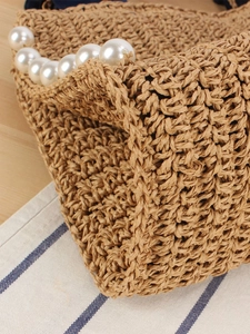 Handwoven straw tote bag with pearl lace trim and textured bohemian style for summer vacation