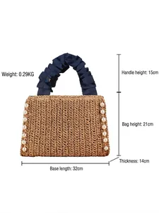 Handmade woven straw tote bag with pearl trim and blue ribbon handles for beach vacations