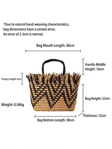 Ethnic straw tote bag with black V-shaped wave pattern and fringe details for beach vacation